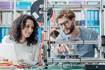 Female and male student working together on an engineering project